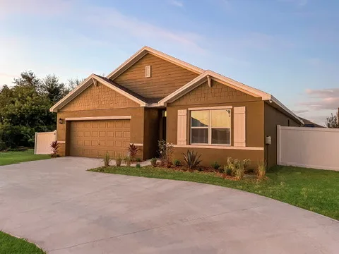 Front exterior of Blue Breeze, a single-family home with a two-car garage and a wide driveway