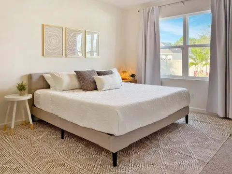 Primary bedroom at Blue Breeze with a large bed and a bright window